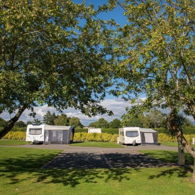 Caravan Pitches with trees in foreground
